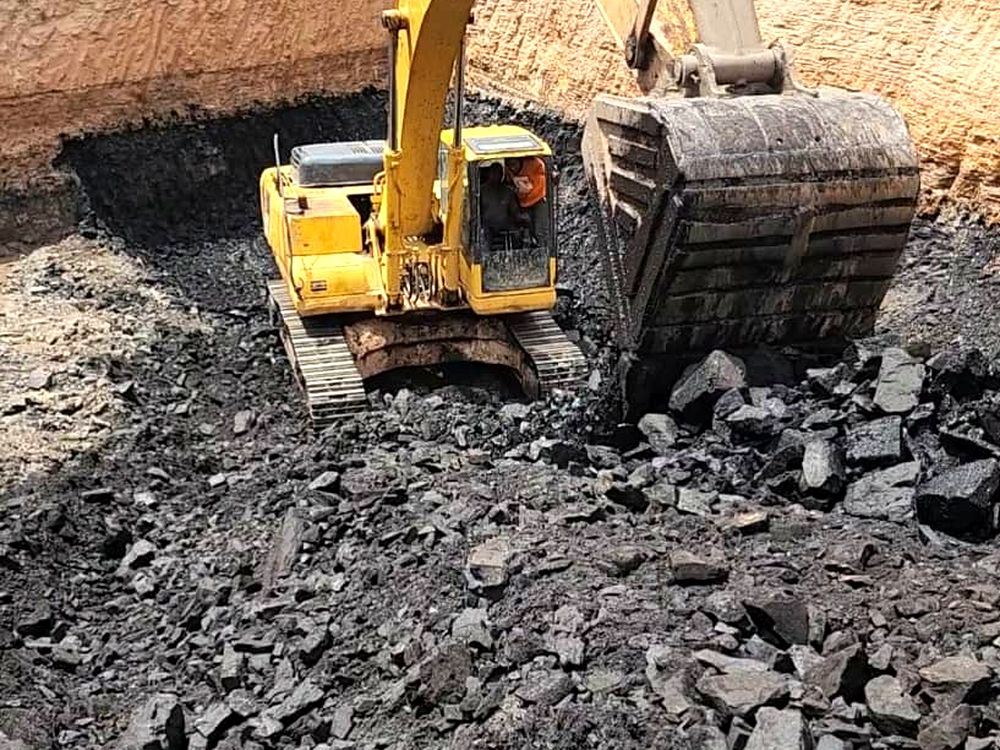 Tracked excavator working a coal seam at an active Dominion mining site
