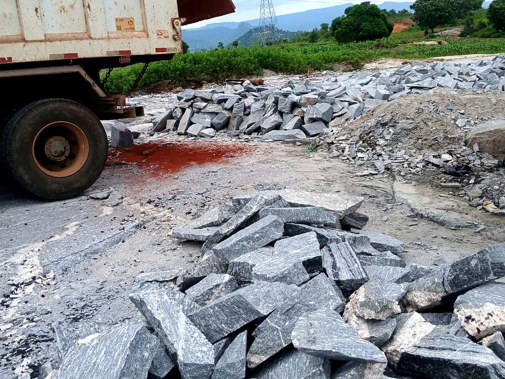 Tipper truck offloading quarried stone at a Dominion project site